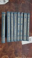 Spine view showing all eight blue gilt-stamped volumes