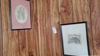 Both framed artworks on wall showing relative sizes and frames