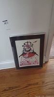 Framed art print leaning against wall showing full frame