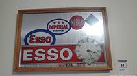 Front view of framed Esso Imperial advertising clock/sign showing logos, dial and frame