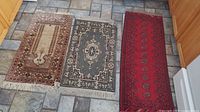 All three rugs laid out side by side on floor