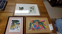 All three framed prints grouped on table