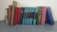 Group shot of all 14 vintage cloth hardcover books standing in a row