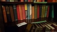 Shelf of mixed vintage cloth-bound hardcovers