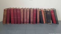 Full row of approximately 15 vintage cloth hardcovers showing color, height and spine wear