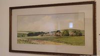 Framed watercolor landscape on wall