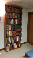 Front view of full height bookcase loaded with books