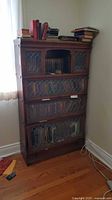 Front view of oak barrister bookcase showing leaded glass panels and books for scale