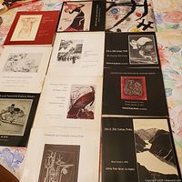 11 vintage Sotheby Parke Bernet auction catalogs arranged flat showing covers with print artwork images and catalog titles.