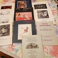 Photo of all 11 Sotheby's auction catalogs spread out, showing covers of various vintage print auction catalogs.