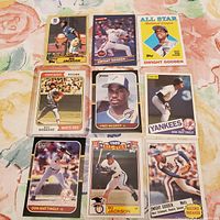 Nine vintage MLB sports cards laid out on a floral surface, featuring Bo Jackson, Fred McGriff, Dwight Gooden, Don Mattingly, and others.