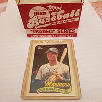 Ken Griffey Jr. rookie card with the original 1989 Topps Baseball Traded Series box behind it, showing card number range 1-T through 132-T.