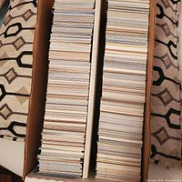 Top view showing two rows of tightly packed baseball cards stored vertically inside a double long cardboard box.