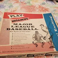Photo of front of game box showing title, baseball catcher and batter illustration, and features listed.