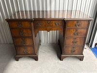 Front view showing entire mahogany desk with nine drawers