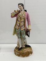 Full view of porcelain gentleman figurine on base