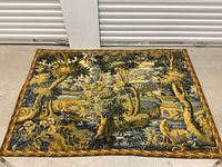 Front view of full tapestry showing scene and border