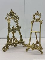 Front view of both ornate cast brass easels