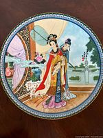 Front view of the porcelain plate showing the full Chinese art design with two women and detailed background.