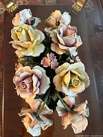 Top view showing arrangement of large and small roses with multicolor palette on fine porcelain.