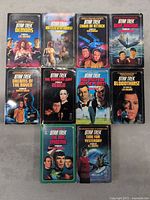 Front covers of all 10 Star Trek novels showing series titles and cover art.