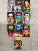Overview photo showing all 10 Star Trek paperback novels laid out on a surface, arranged in three rows.