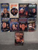 Front covers of 10 Star Trek The Next Generation paperback novels showing various characters from the series.