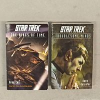 Front covers of two Star Trek novels: The Rings of Time and Troublesome Minds