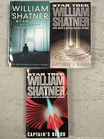 Three paperback Star Trek novels by William Shatner, stacked side by side, titles visible on cover.