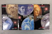 Front covers of three Worlds of Star Trek Deep Space Nine paperback books showing titles and author names.