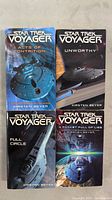 Four Star Trek Voyager novels with cover art visible showing titles and author's name Kirsten Beyer.