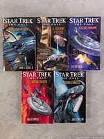 Front covers of five Star Trek The Fall paperback novels showing detailed cover art and titles.