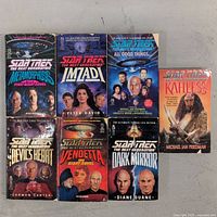Seven paperback Star Trek The Next Generation novels with cover art showing characters and titles, arranged in two rows.