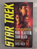Front cover of the hardcover Star Trek book titled 'More Beautiful Than Death' showing characters Captain Kirk, Spock, and Uhura in a dramatic sci-fi theme.