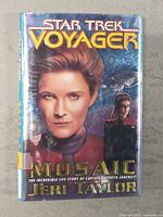 Front cover of Star Trek Voyager Mosaic hardcover book featuring Captain Kathryn Janeway and starship.