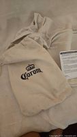 Drawstring bag with Corona logo, hammock fabric visible