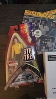 Sealed Fan Expo Exclusive Captain Kirk figure beside Star Trek record sleeves