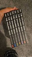 Spine view of all seven hardcover volumes 1-7