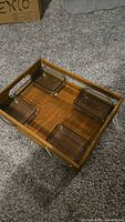 Top view of wooden tray with four glass dishes in place