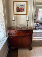 Front view of sideboard with carved drawer and cabinet doors closed