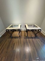 View of both end tables side by side showing glass tops framed by Mactan stone and wrought iron base.