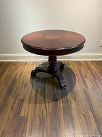 Full view of round table showing top, pedestal and feet