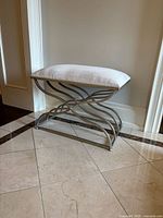 Hall bench from side angle showing metal curved leg design and cushioned seat