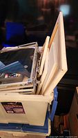 stack of blank canvases in storage bin