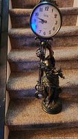 Full view of statue clock on stairs
