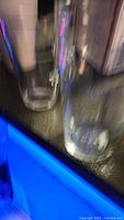 two clear cylindrical glasses on countertop
