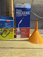 Boxed battery float charger, boxed propane torch, orange funnel