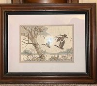 Framed embroidered geese artwork in dark wood frame
