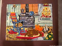 Needlepoint of cabin interior with stove, rocking chair, pumpkins, dog and cat