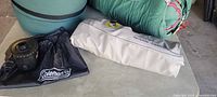 Sleeping bags, air mattress and Coleman pump bag on table
